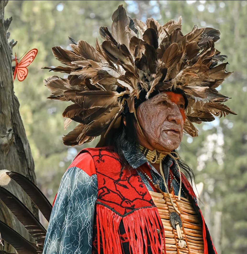Indigenous elder in ceremonial feather headdress
